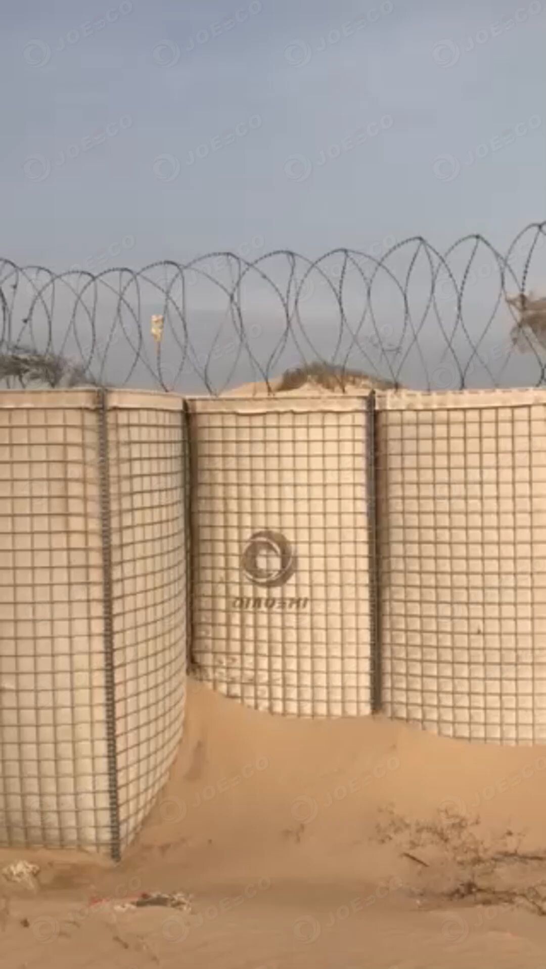 In the Gulf of Aden, the JOESCO military barriers stand tall in the wind. thumbnail 1